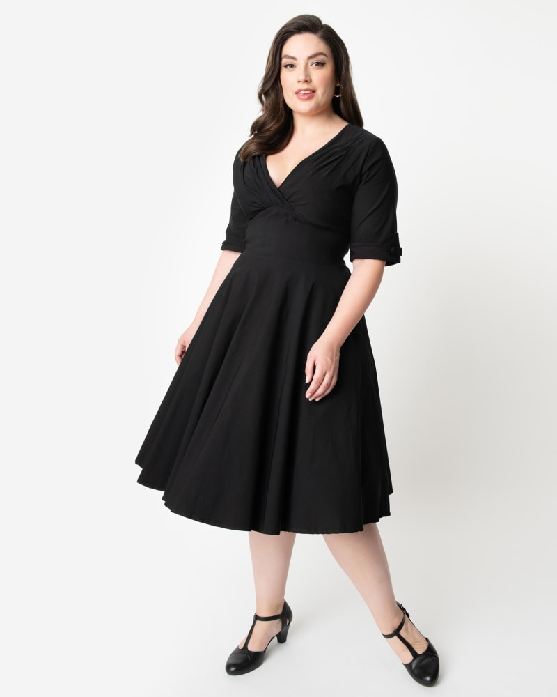 Front of a model wearing a size 1X/16 Unique Vintage Plus Size Black Delores Swing Dress with Sleeves in Black by Unique Vintage. | dia_product_style_image_id:270058